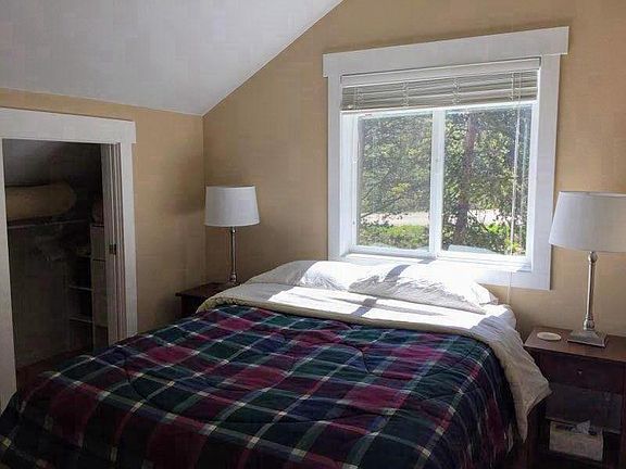 Bedroom with Queen sized bed, closet, dresser.