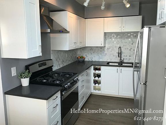 Renovated kitchen with quartz coutertops and gas stove.