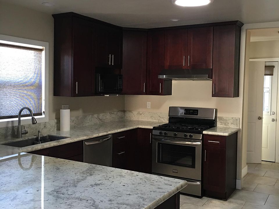 Kitchen, wide granite countertop doubles as a sitting and eating area