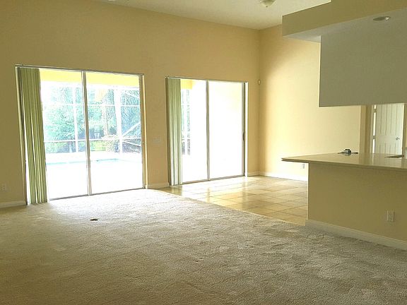 VIEW ACROSS FAMILY ROOM OUT TOWARD POOL AREA - BOTH SETS OF