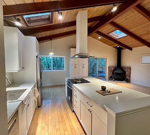 Kitchen island has bar for stools on the opposite side.
