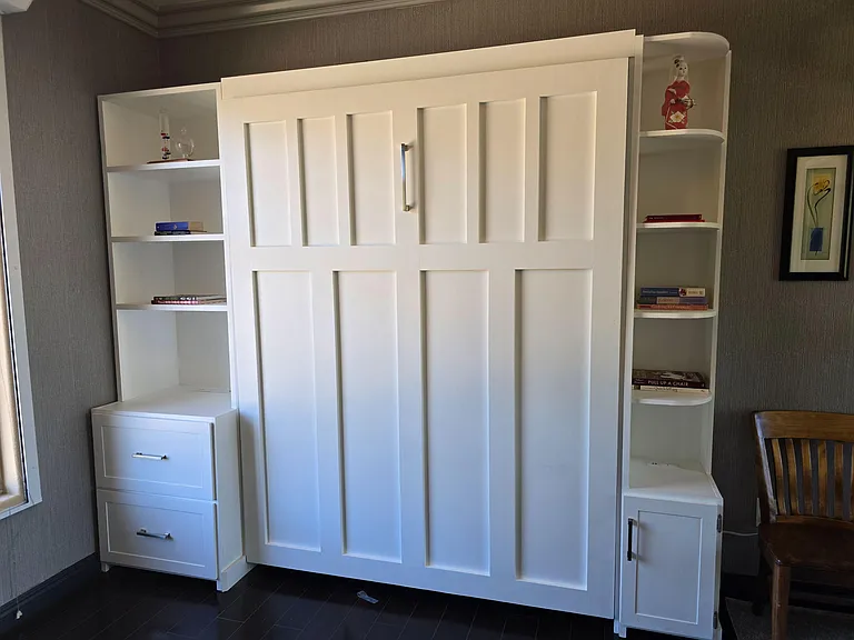 Versatile flex space features a built-in wall bed with integrated shelving and drawers for efficient storage and daily use.