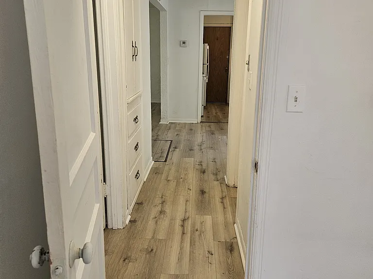 from SE bedroom looking through hallway toward living /dining room; doorway into kitchen
