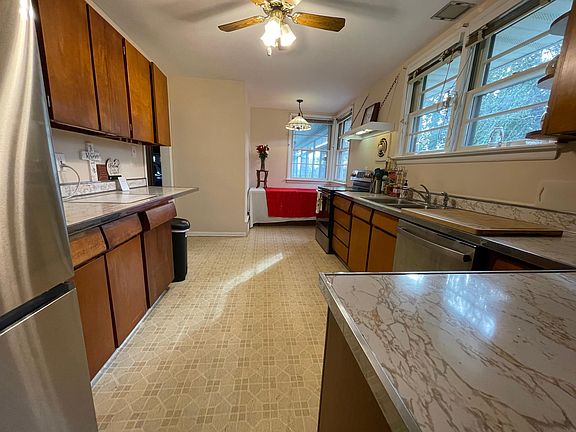 Kitchen with nice view of the Sunroom and Fenced Back yard