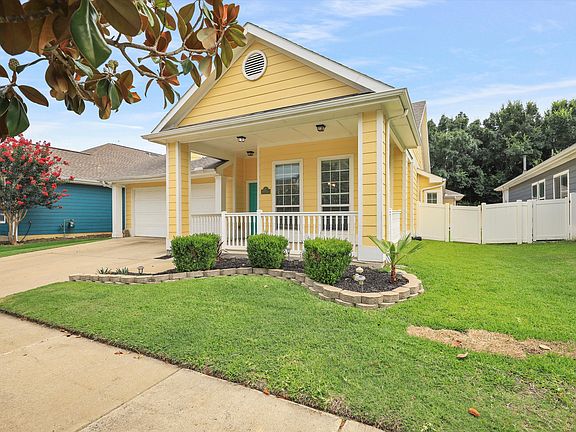 View of front of house with a porch and a front lawn