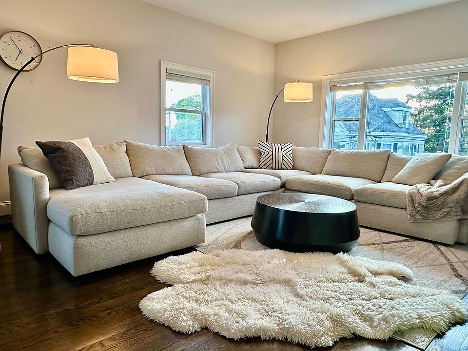 Spacious, sun-filled living room with hardwood floors and flexible space for relaxing, entertaining, or play.