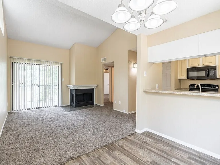 Open concept and corner fireplace and galley kitchen