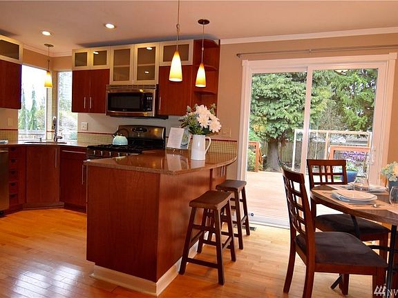 Open-floor Kitchen & Dining Area Looks Out to Deck & Back Yard