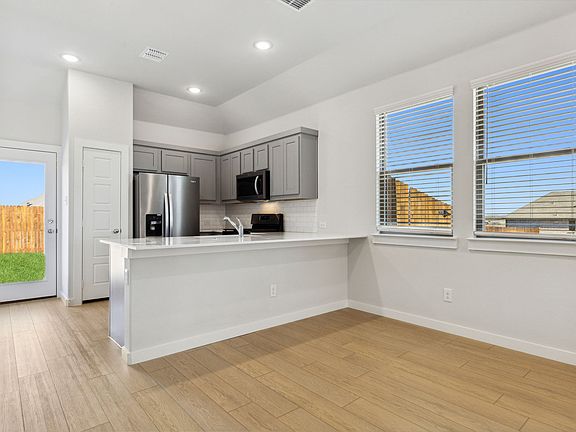 Kitchen in the Ash home plan by Trophy Signature Homes - REPRESENTATIVE PHOTO