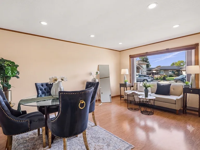 Oversized picture window floods the living room with natural light
