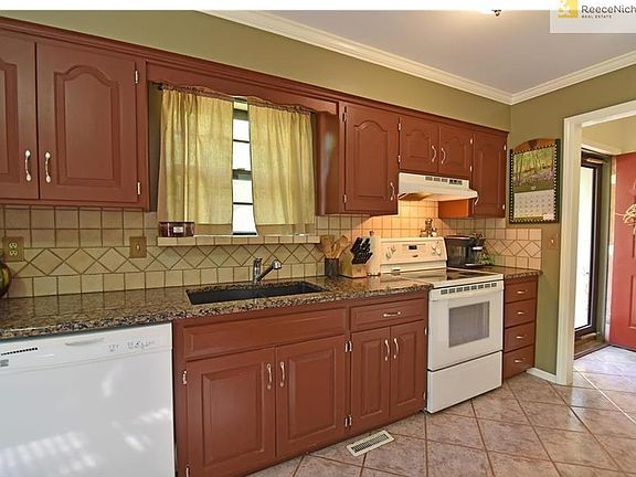 Kitchen boasts granite counters and easy care tile flooring