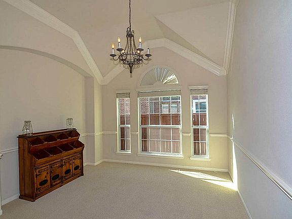 Formal dining room with crown and chair molding,high ceilings, decorative light fixture, located adj