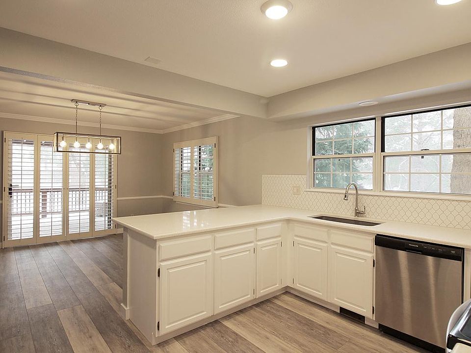 Kitchen with new quartz counters, granite sink, and large breakfast bar.