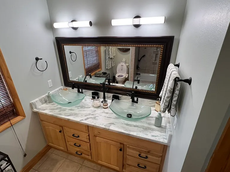Newly remodeled bath. Stunning, newly installed, quartzite counter tops. Double vanity with two vessel sinks and Lefton faucets. Adjustable led lighting with phone app.