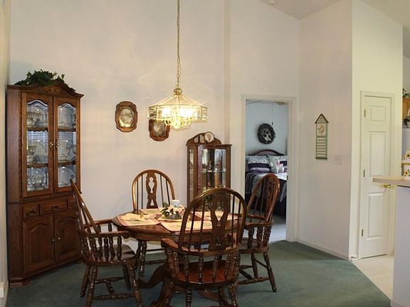 Dining room with vaulted ceiling and over table lighting.