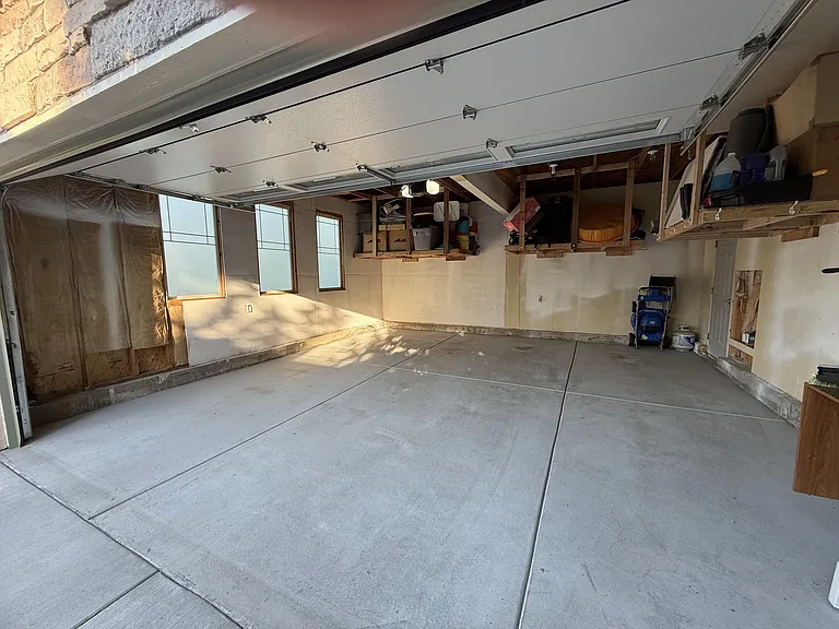 Oversized 2 car garage with build in storage shelving (cars and additional equipment fit under the shelves).