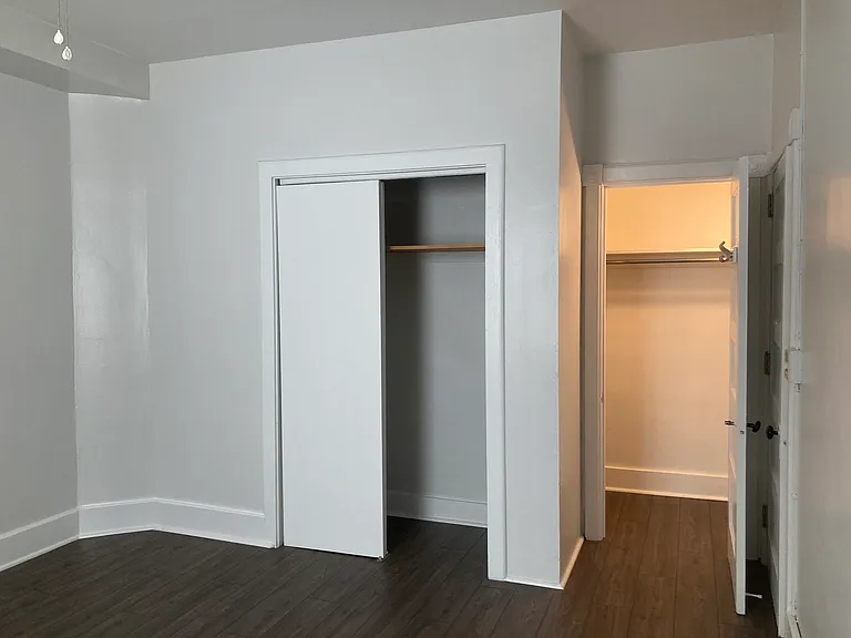 Master bedroom, ceiling fan, two closets. 2nd closet is a walk-in with lighting, multiple shelves and full-length mirror attached to closet door.
