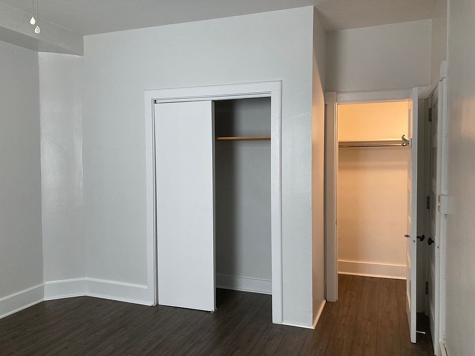 Master bedroom, ceiling fan, two closets. 2nd closet is a walk-in with lighting, multiple shelves and full-length mirror attached to closet door.