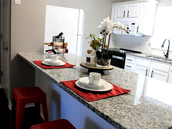 Oversized granite island bar with seating, perfect for entertaining and open-concept living.