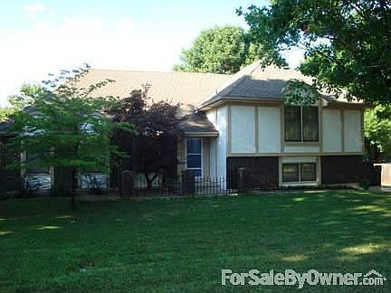 Street view : Brick and Stucco facade with mature trees and extensive landscaping