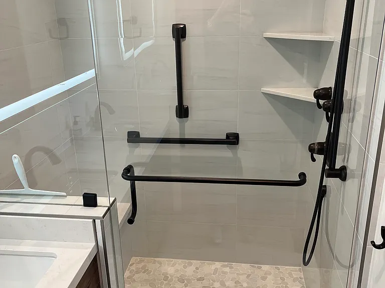Master bathroom newly remodeled with lighted vanity, dual sinks, heated floors, double shower head, toilet separated by door