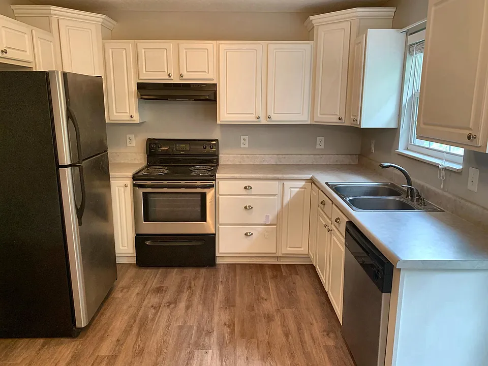 Stylish white kitchen with stainless steel appliances
