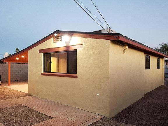 Freshly painted stucco over brick exterior with motion sensing lighting.