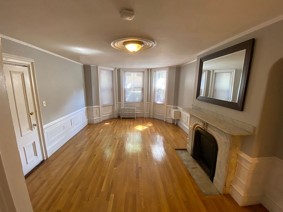 Front Room used as either Large Bedroom or Large Living room. Bay windows, marble fireplace.
