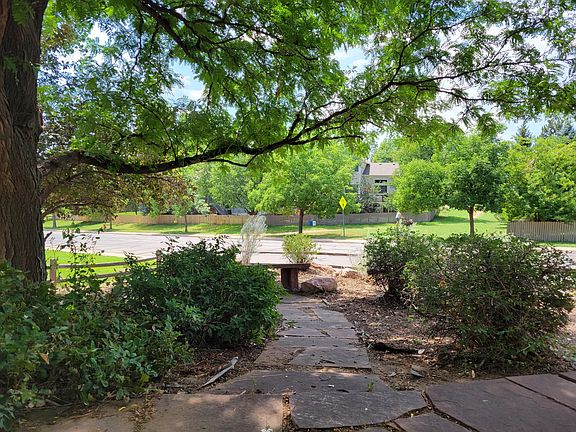 Xeric landscaping, including flagstone walkway and bench