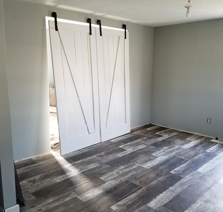 Locally made barn doors close off the living room from the 3rd bedroom or office, behind the doors.