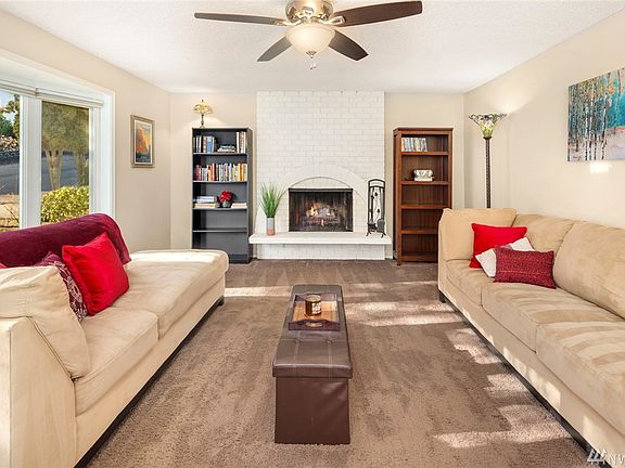 Upper level living room centered around the trendy white painted brick wood burning fireplace, soaked in natural light!