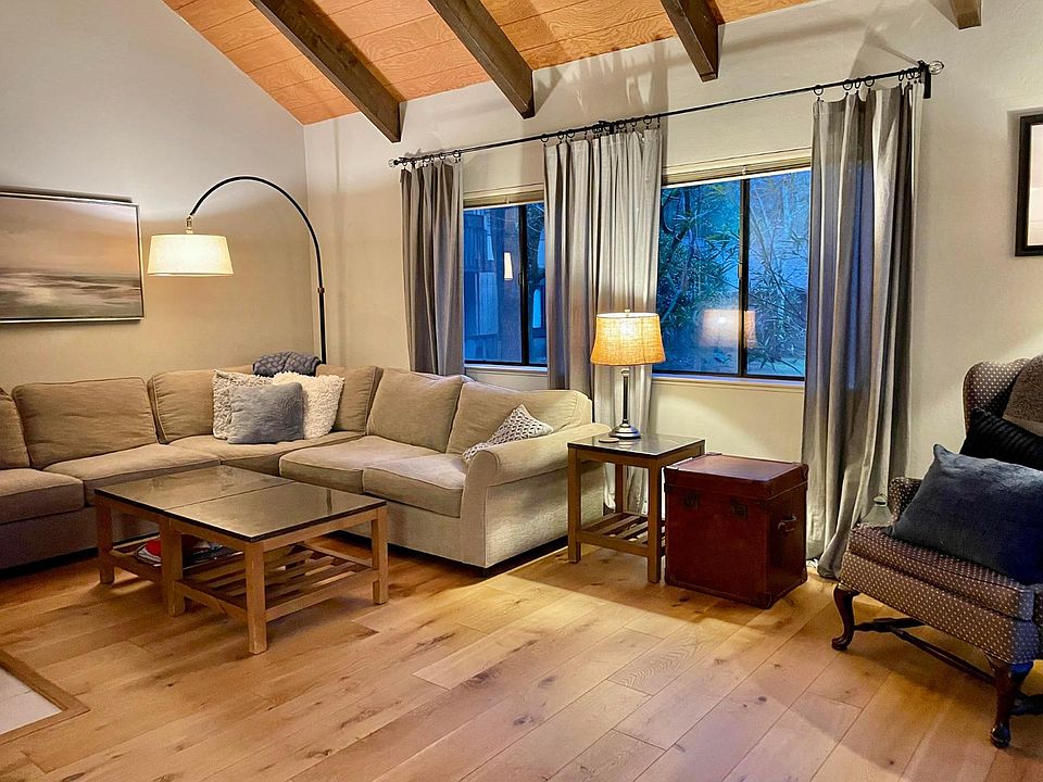 Living room with vaulted ceiling and slider to private patio