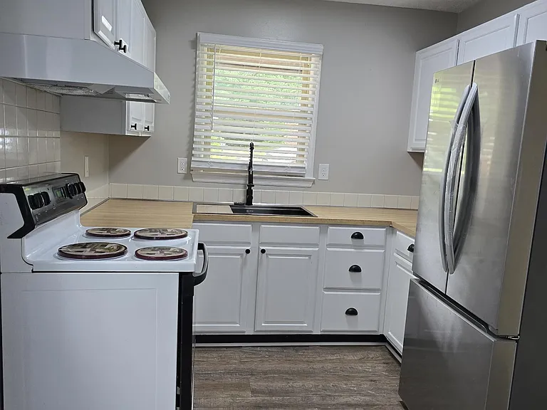 Updated kitchen: new sink, new refrigerator with ice maker; newly painted cabinets. Electric range works great and is as clean as new!