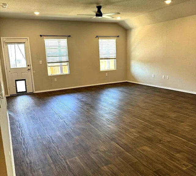 Open living room with natural light: ideal for relaxing or entertaining. Large common area perfect for roommates or family living. Dog/cat door installed on back door.