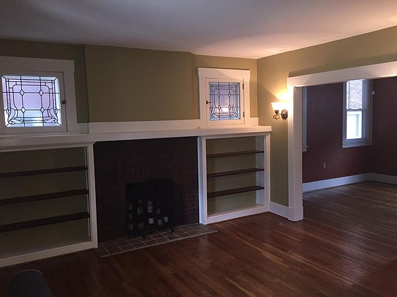 Living Room (fireplace is not operational). Shelves are built in. Dining room in background is a more neutral color now