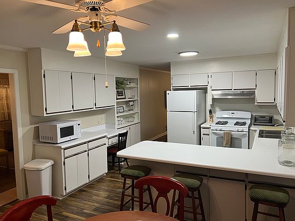 Kitchen: Enter fr the car port into the kitchen for a stair less access- It leads into the living/dining or den. Utility room is off the kitchen with full sized washer and dryer iron, and ironing board, and deep freezer exterior door access to side yard.