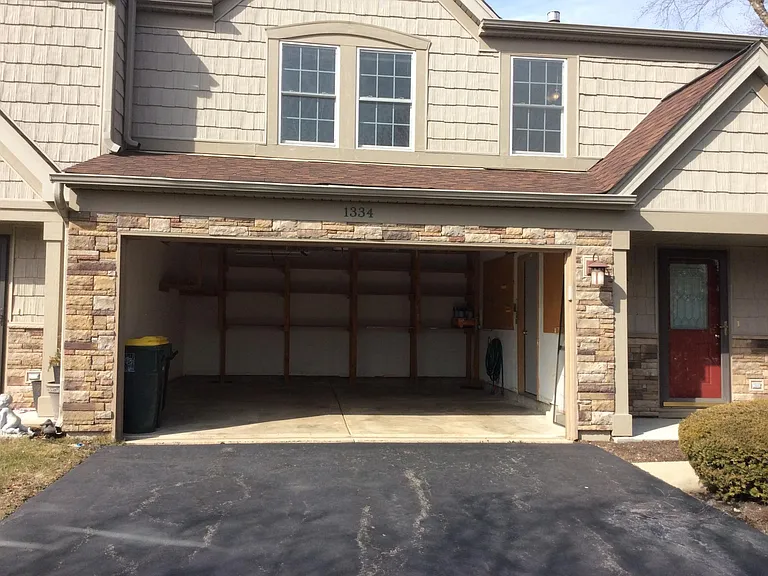 Garage with 2 car storage plus build in wood storage. Driveway with almost 2 more car parking
