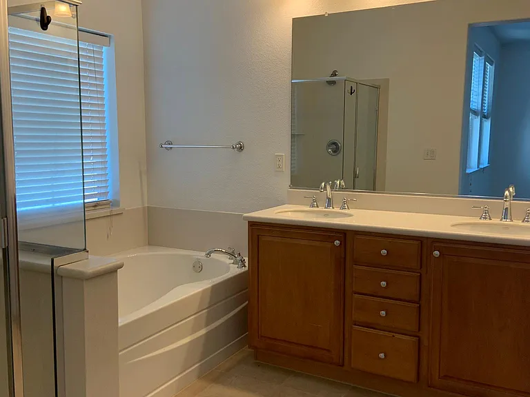 Master bathroom with dual sinks, separate shower and tub.