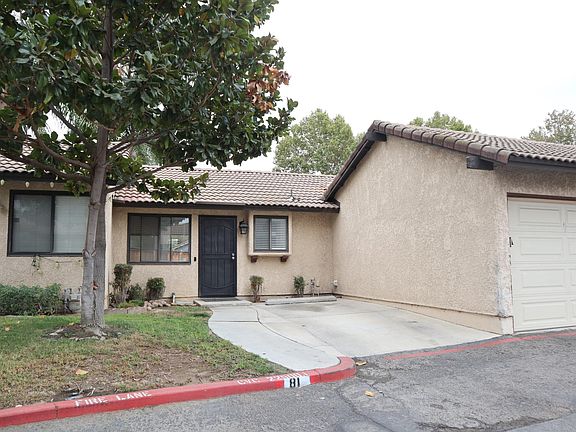 Single story town home with attached garage and driveway