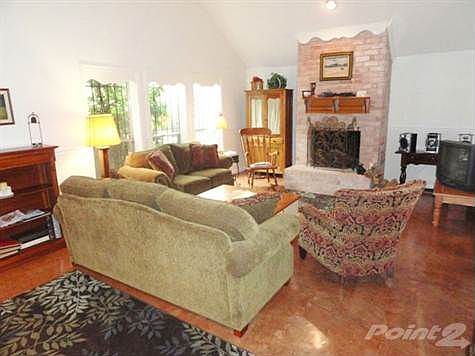 Stained concrete floors, high ceiling, & wood burning fireplace!