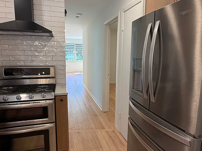 Kitchen with hallway view into living room