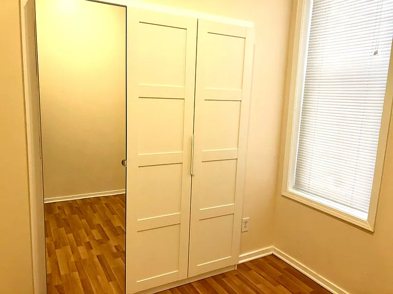 Three door custom closet, (one door is a mirror), in the smaller bedroom, which fits a full/double bed.