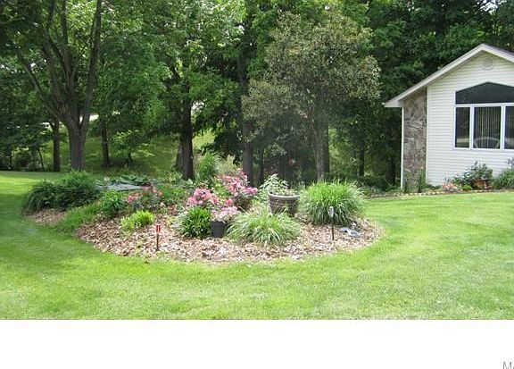 Left side of home, opposite garage...
