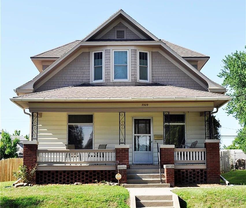 Front view with inviting porch.