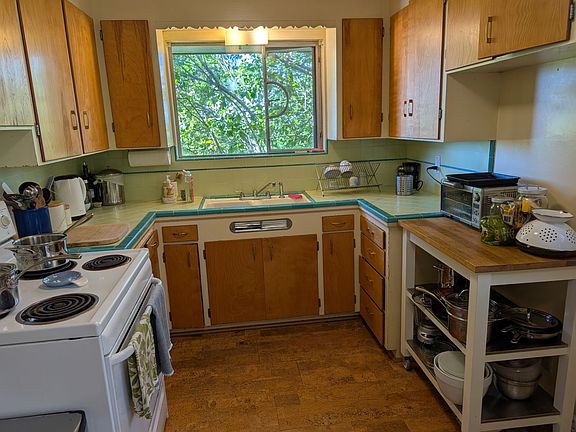 Kitchen has original period tile, cork floors, garden view.