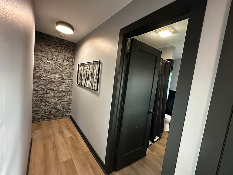 Bold black molding, doors and hardware paired with stone accent walls, updated lighting and neutral flooring stand out from all other homes.