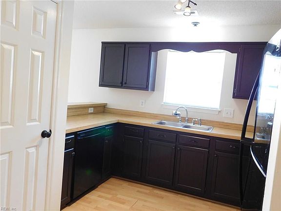 Kitchen with pantry at left. Kitchen overlooks the Great Room.
