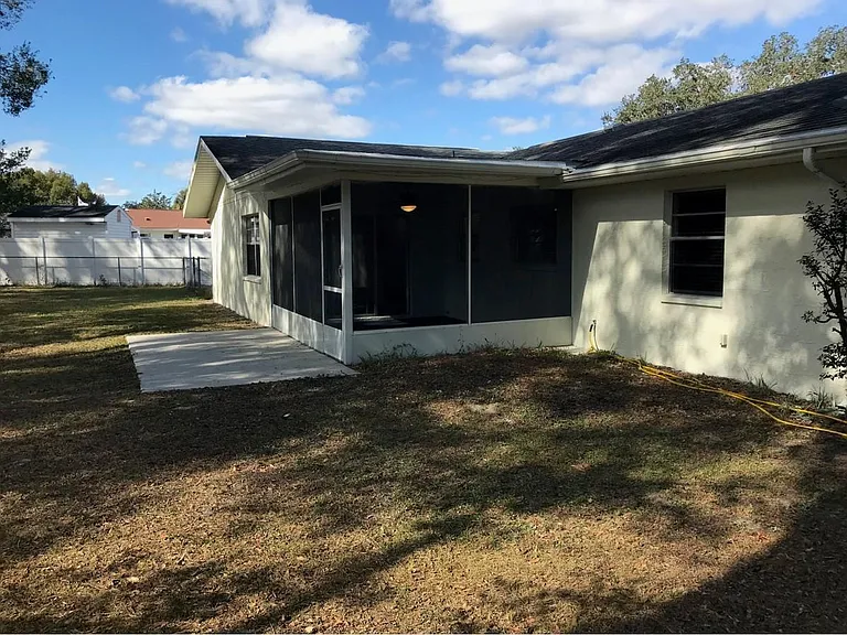 Rear of house showing patio and screened porch.
