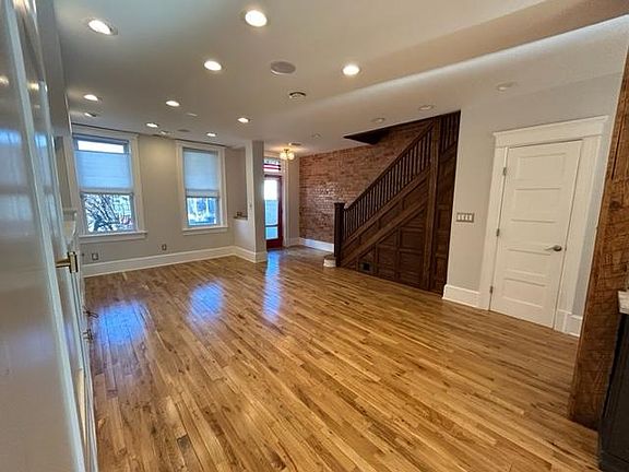 Complete with architectural details like period staircase and exposed brick walls.