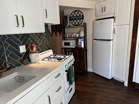 Kitchen with w/d, sink, small range, refrigerator, coffee station (bakers rack)